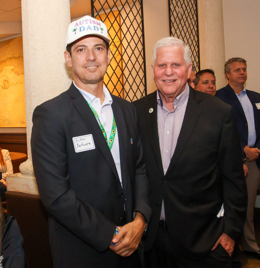Michael Miller and Miami Autism Dad pose for a photo together.