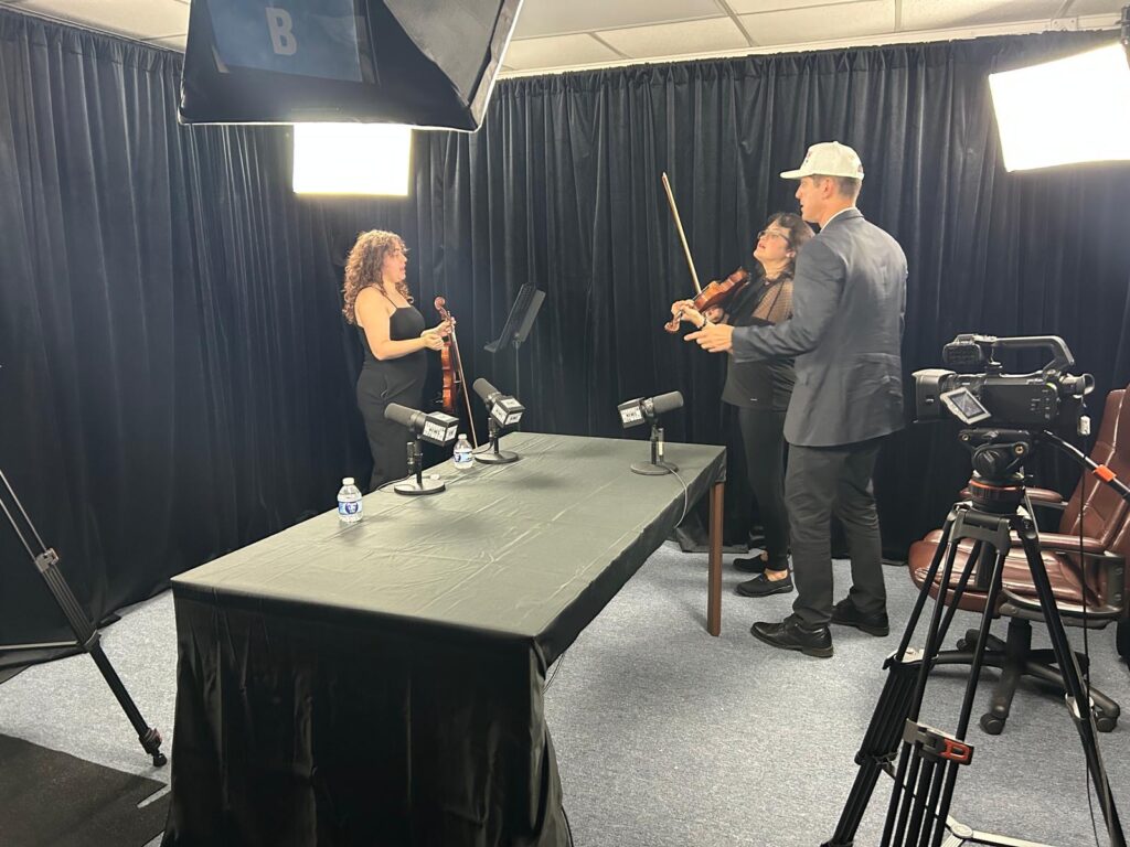Miami Autism Dad Victor Antunez preps for the podcast with autistic violin duo SofistyKat Strings.