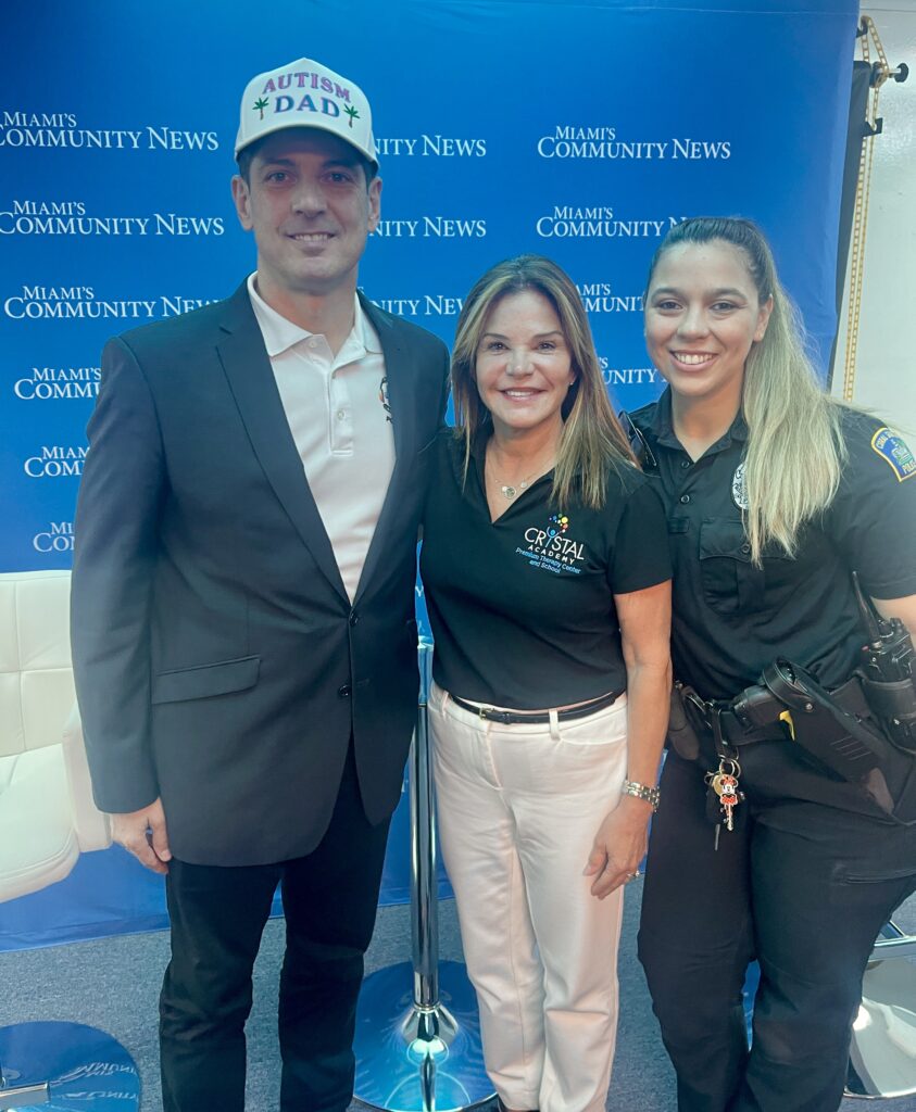 Miami Autism Dad posing for a photo with Maria Palacios of Crystal Academy & Ofc. Silva of Coral Gables PD