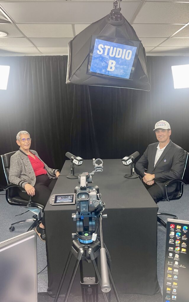 Ire Diaz, President and CEO of The Advocacy Network on Disabilities and Miami Autism Dad Victor Antunez smiling for a photo in Studio B at Miami's Community Newspapers.