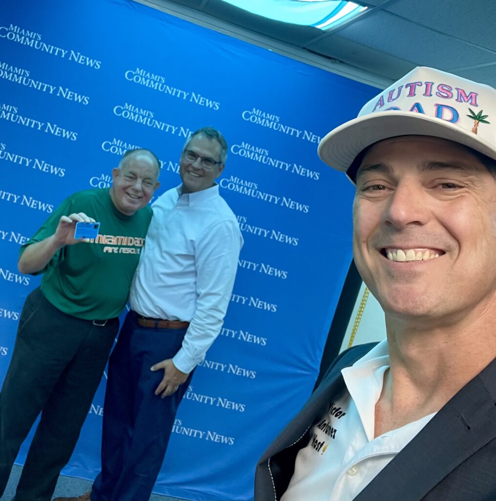 Kent Schomber, Bart Barta, and Miami Autism Dad Victor Antunez smiling for a photo.