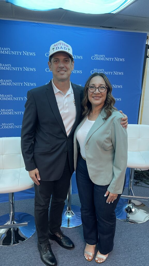 Miami-Dade ADA Project Administrator Jody Cox & Miami Autism Dad Victor Antunez smiling for a photo at Miami's Community Newspapers.