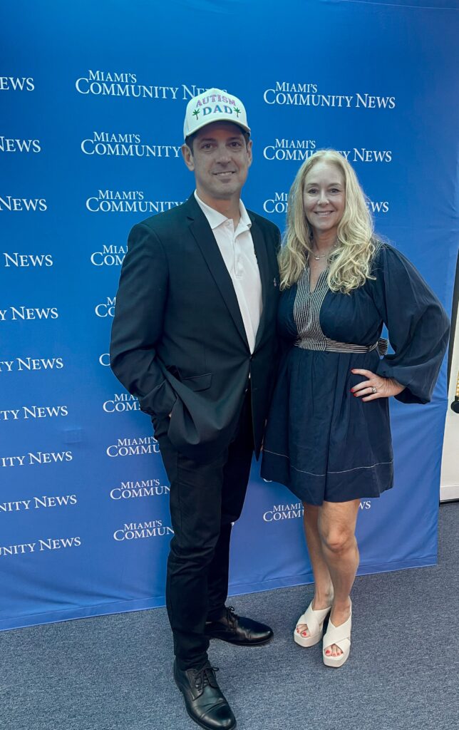 Rachel Spector of The Children’s Trust and Miami Autism Dad Victor Antunez smiling for a photo at Miami's Community Newspapers.